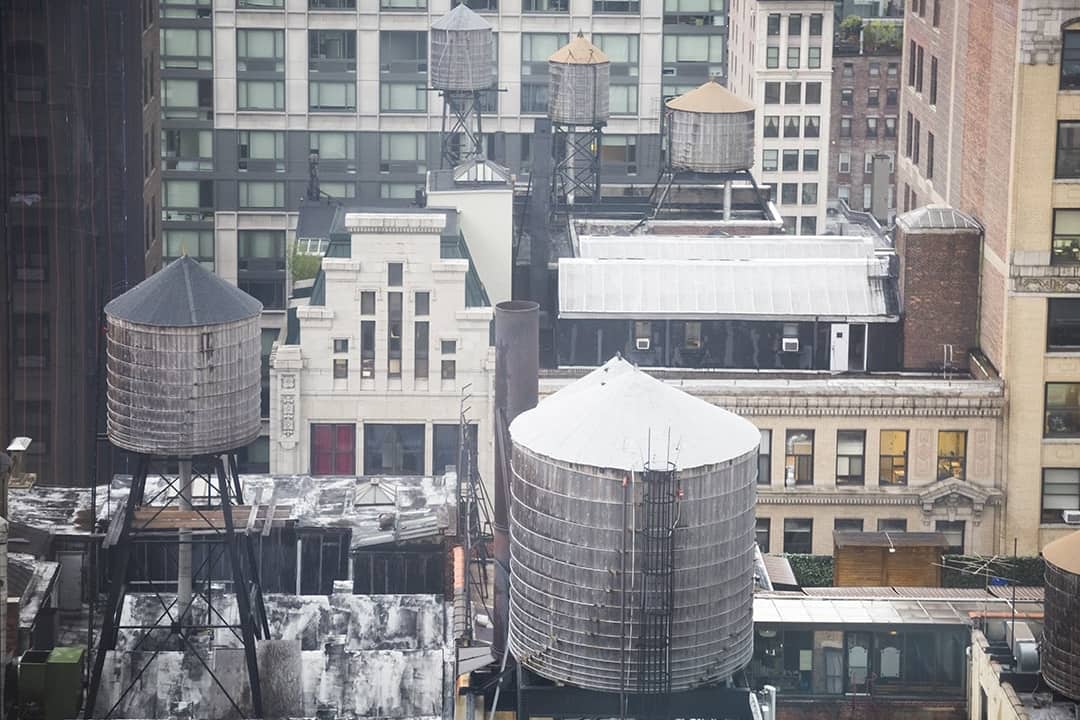 Water towers seen on the rooftops skyline of New York City, USA.
